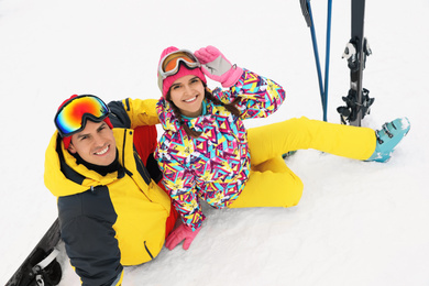 Lovely couple with equipment at ski resort. Winter vacation