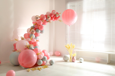 Photo of Room decorated with colorful balloons and spikelets for party