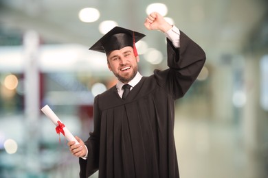 Happy student with graduation hat and diploma indoors