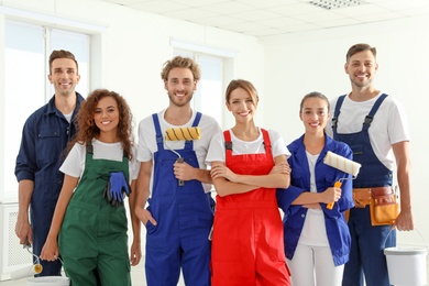 Team of professional painters with tools indoors