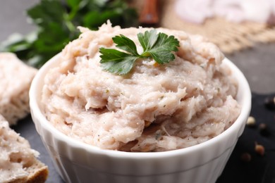 Photo of Delicious lard spread with parsley in bowl, closeup