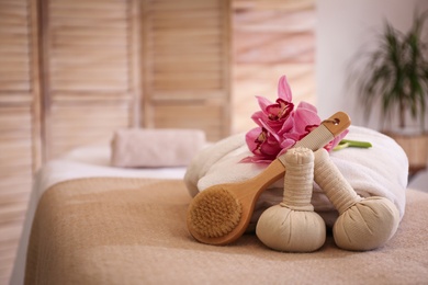 Photo of Beautiful spa accessories in massage room, space for text