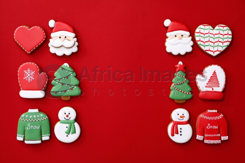 Different Christmas gingerbread cookies on red background, flat lay. Space for text
