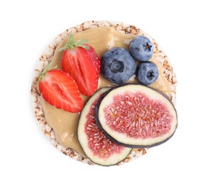 Photo of Tasty crispbread with peanut butter, berries and figs on white background, top view