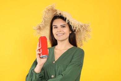 Photo of Beautiful happy woman holding red beverage can on yellow background