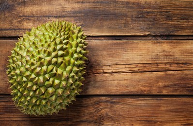 Ripe durian on wooden table, top view. Space for text