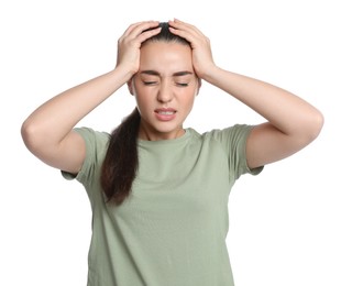 Young woman suffering from headache on white background