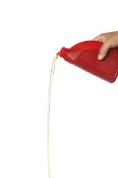 Man pouring motor oil from red container on white background, closeup