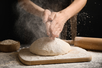 Woman with dough at grey table, closeup. Making pasta