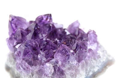 Photo of Beautiful purple amethyst gemstone on white background, closeup