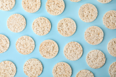 Puffed rice cakes on light blue background, flat lay