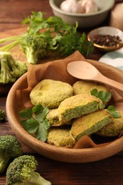 Photo of Tasty vegan cutlets and ingredients on wooden table