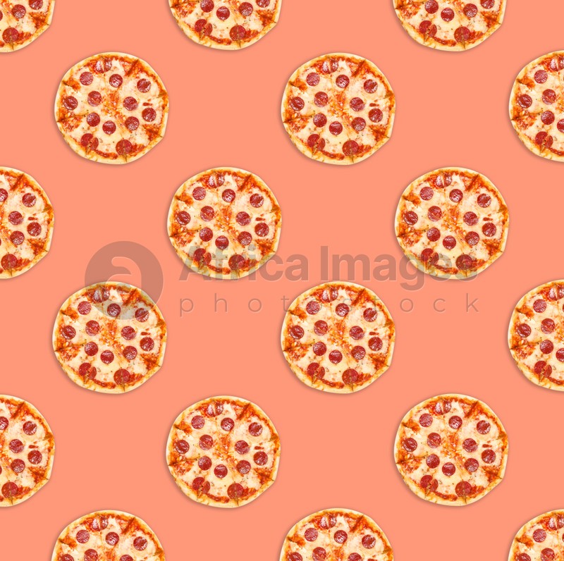 Many delicious pepperoni pizzas on coral background, flat lay. Seamless pattern design