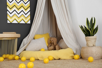 Baby room interior with play tent and cute posters