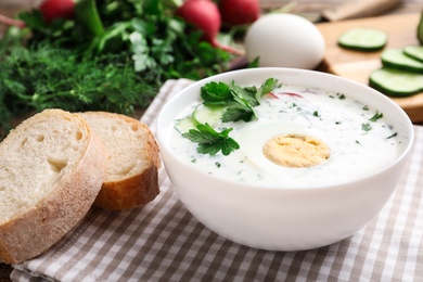 Delicious cold summer soup with kefir served on table