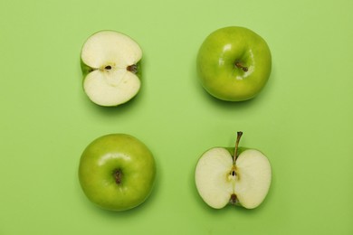 Fresh ripe apples on green background, flat lay