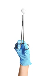 Doctor in sterile glove holding medical clamp with cotton ball on white background