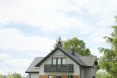 Modern building with grey roof outdoors on spring day