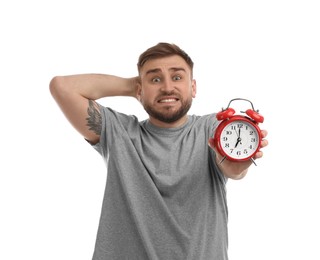 Emotional overslept man with alarm clock on white background. Being late concept