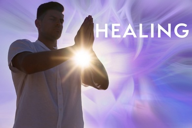Man meditating on color background. Healing concept