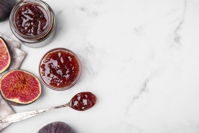 Photo of Tasty sweet fig jam and fruits on white marble table, flat lay. Space for text