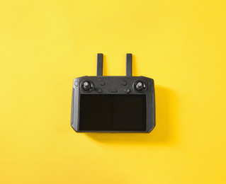 New modern drone controller on yellow background, top view