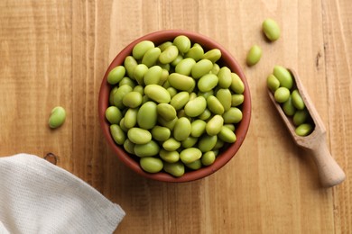 Photo of Organic edamame beans on wooden table, flat lay