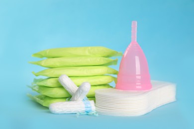 Menstrual pads and other hygiene products on light blue background