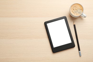 Modern e-book reader, coffee and pencil on wooden table, flat lay. Space for text