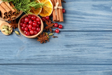 Flat lay composition with mulled wine ingredients on blue wooden table. Space for text