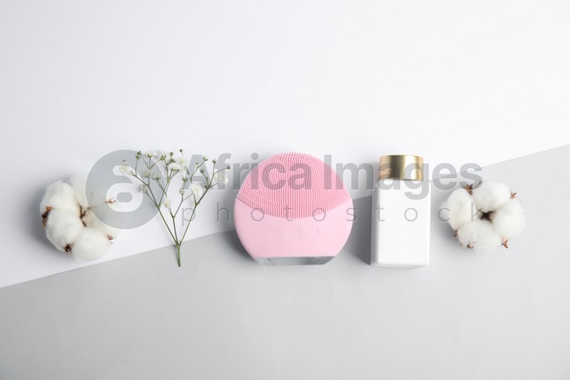 Photo of Flat lay composition with face cleansing brush on color background. Cosmetic accessory