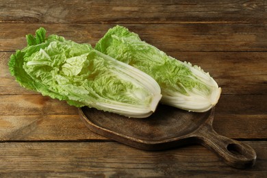 Cut fresh ripe Chinese cabbage on wooden table