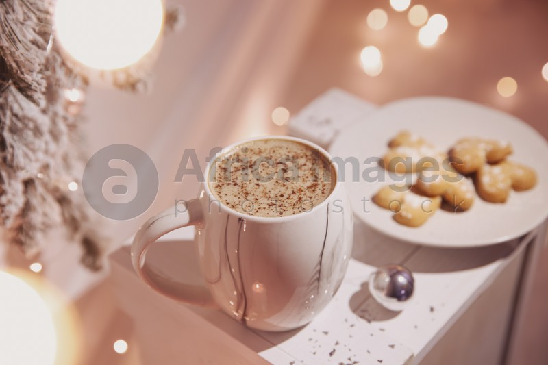 Cup of tasty hot drink and cookies indoors. Christmas atmosphere