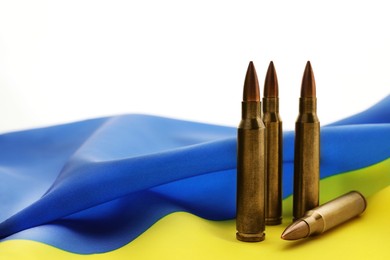 Bullets and national flag of Ukraine on white background