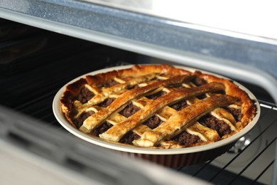 Photo of Delicious meat pie in oven, closeup view