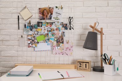 Stylish workplace with stationery and vision board