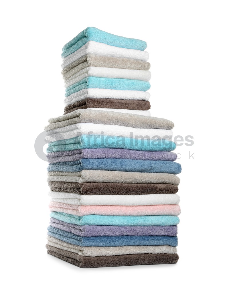 Different fresh soft terry towels on white background