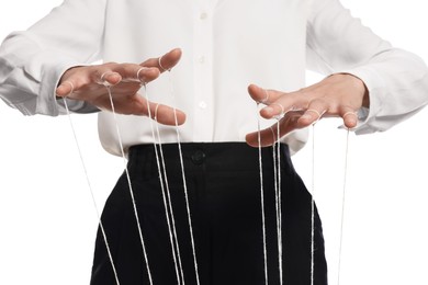 Photo of Woman in formal outfit pulling strings of puppet on white background, closeup
