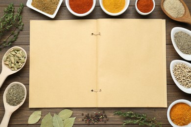 Photo of Blank recipe book surrounded by different ingredients on wooden table, flat lay. Space for text