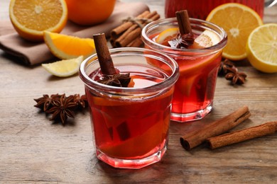 Aromatic punch drink and ingredients on wooden table