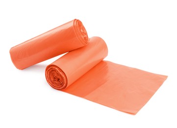 Rolls of orange garbage bags isolated on white