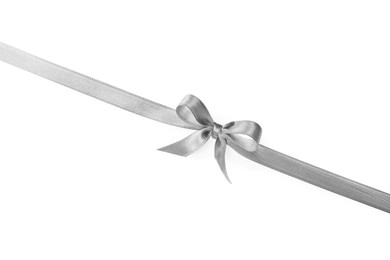 Silver satin ribbon with bow on white background, top view