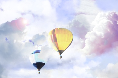 Fantastic dreams. Hot air balloons in sky with fluffy clouds 