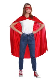 Confident woman wearing superhero cape and mask on white background
