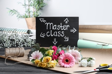 Card with words Master Class and supplies for flower arrangement on grey wooden table