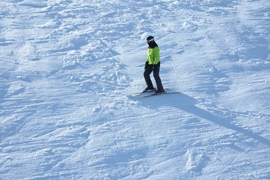 Photo of Male skier on slope at resort. Winter vacation