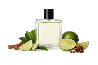 Photo of Bottle of perfume, lime and spices on white background