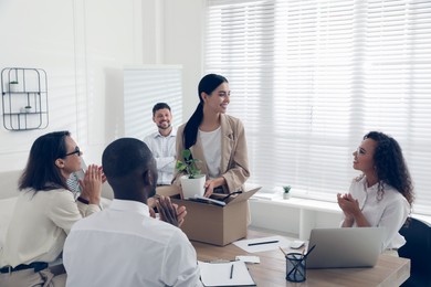 Photo of Group of coworkers welcoming new employee in team indoors
