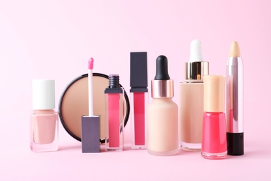Different luxury decorative cosmetics on pink background
