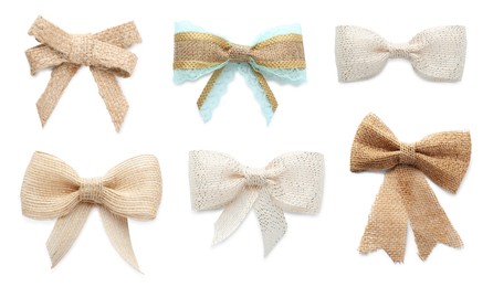 Set with different pretty burlap bows on white background